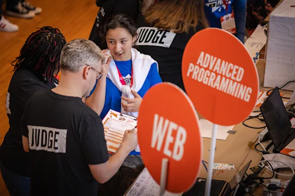 Participants and judges discussing a project at Coolest Projects Ireland.