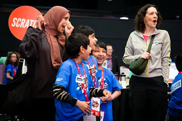 An image of two women and three children celebrating at Coolest Projects UK.