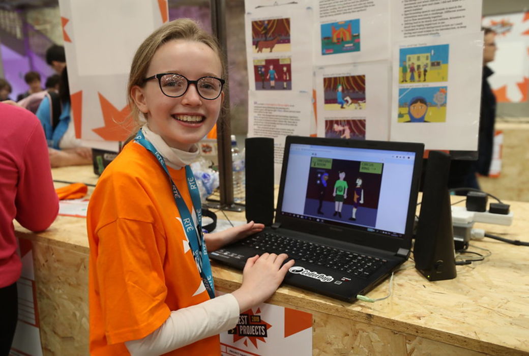 Girl building a coding project on a laptop