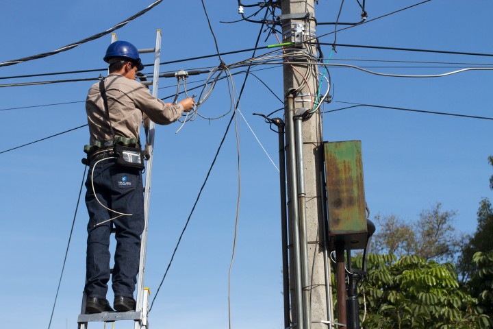 lineman with ladder on powerlines