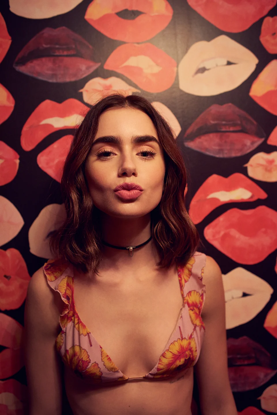 Lily Collins in a pink/orange bra.