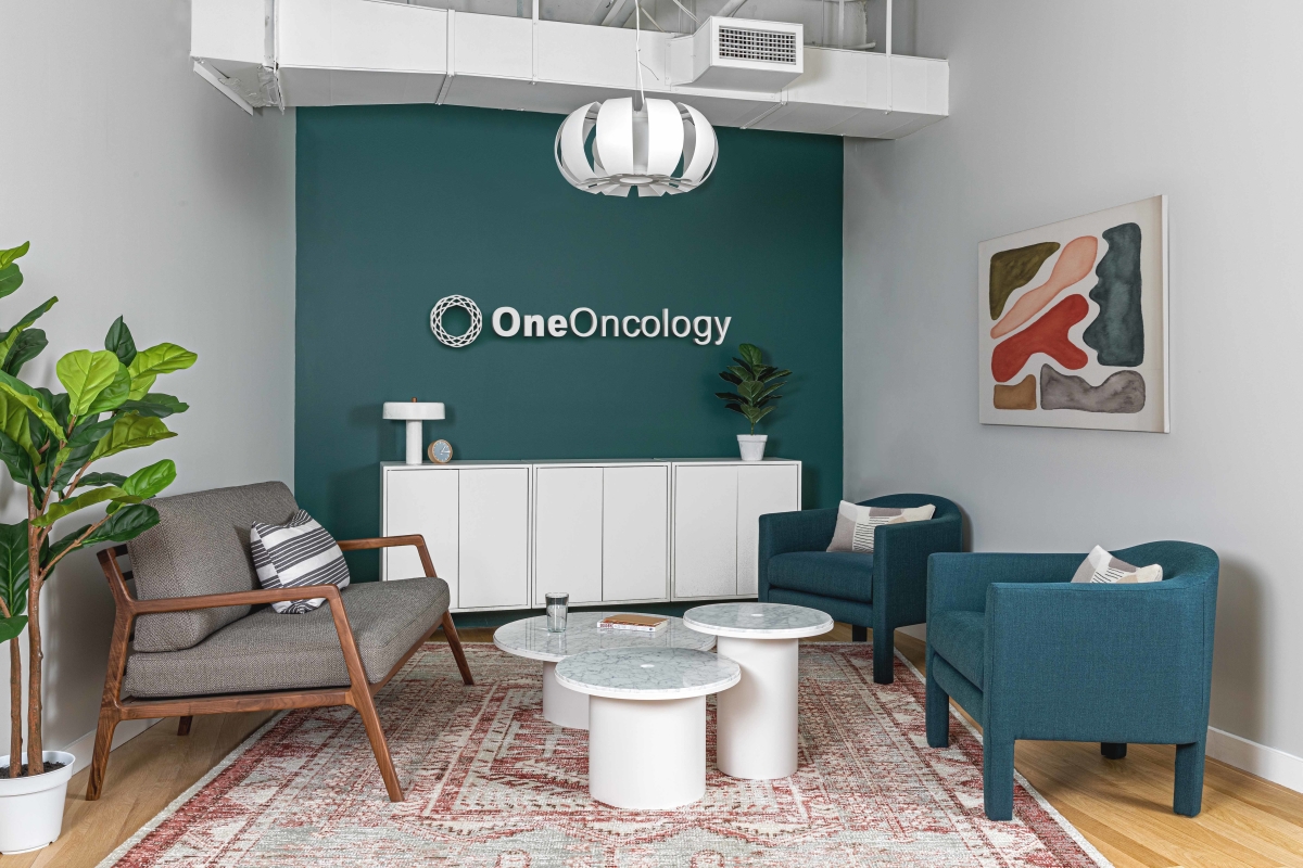 Oneoncology office renovation interior design by Basicspace. The lobby and waiting area is professional but cozy featuring brand colors.