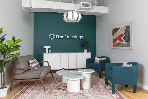 Oneoncology office renovation interior design by Basicspace. The lobby and waiting area is professional but cozy featuring brand colors.