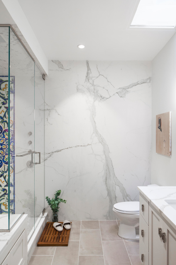Park Slope Brownstone bathroom residential interior design renovation by Basicspace. Full large slab porcelain marble wall with white vanity, tan flooring and glass enclosed steam shower.