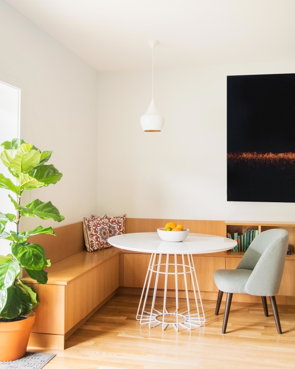 Jersey City Condo residential interior design by Basicspace. Warm toned woods contrast white space with clean dining breakfast nook. Bench wraparound seating.