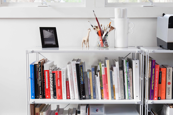 Cohasset Cabin residential interior design by Basicspace. Detail of books on a shelving unit.