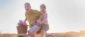 Couple on bicycle after orthopaedic joint replacement treatment.