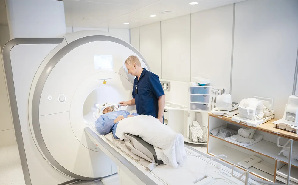 Patient undergoing an MRI scan with a doctor present.