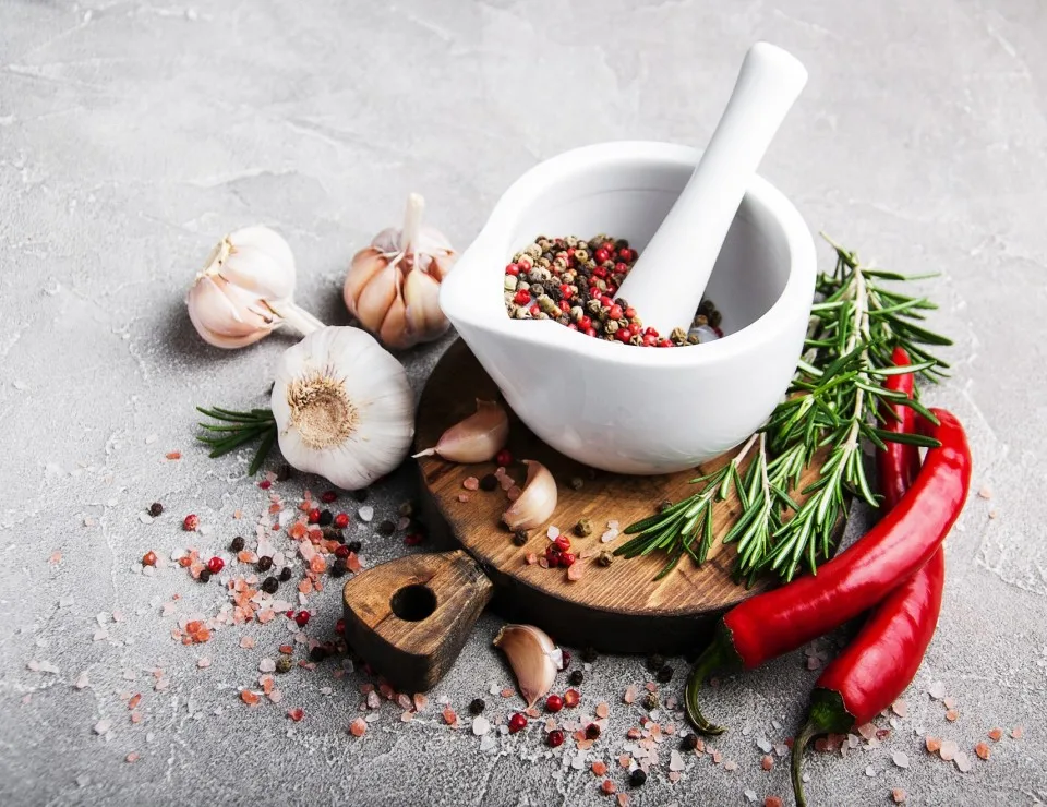 Garlic, spices and a mortar and pestle