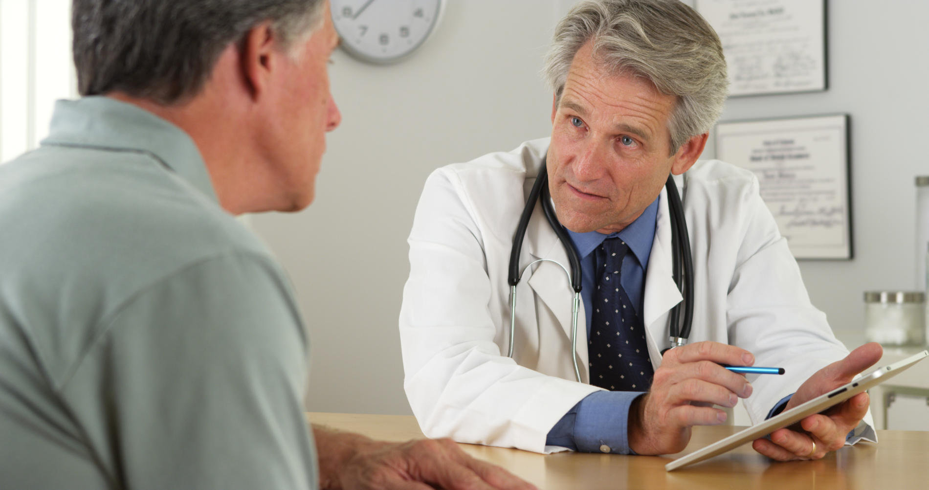 Doctor speaking to man about prostate cancer treatment options.
