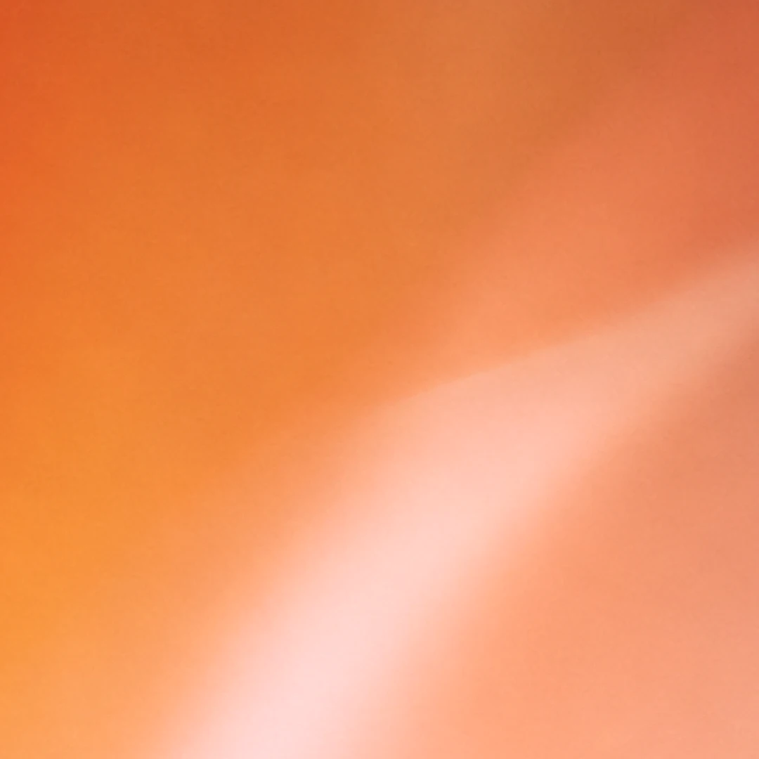 Abstract orange wallpaper with soft peach highlights.