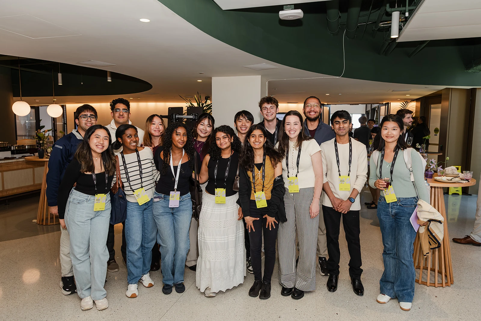 Photograph of a group of smiling people wearing badges around their necks