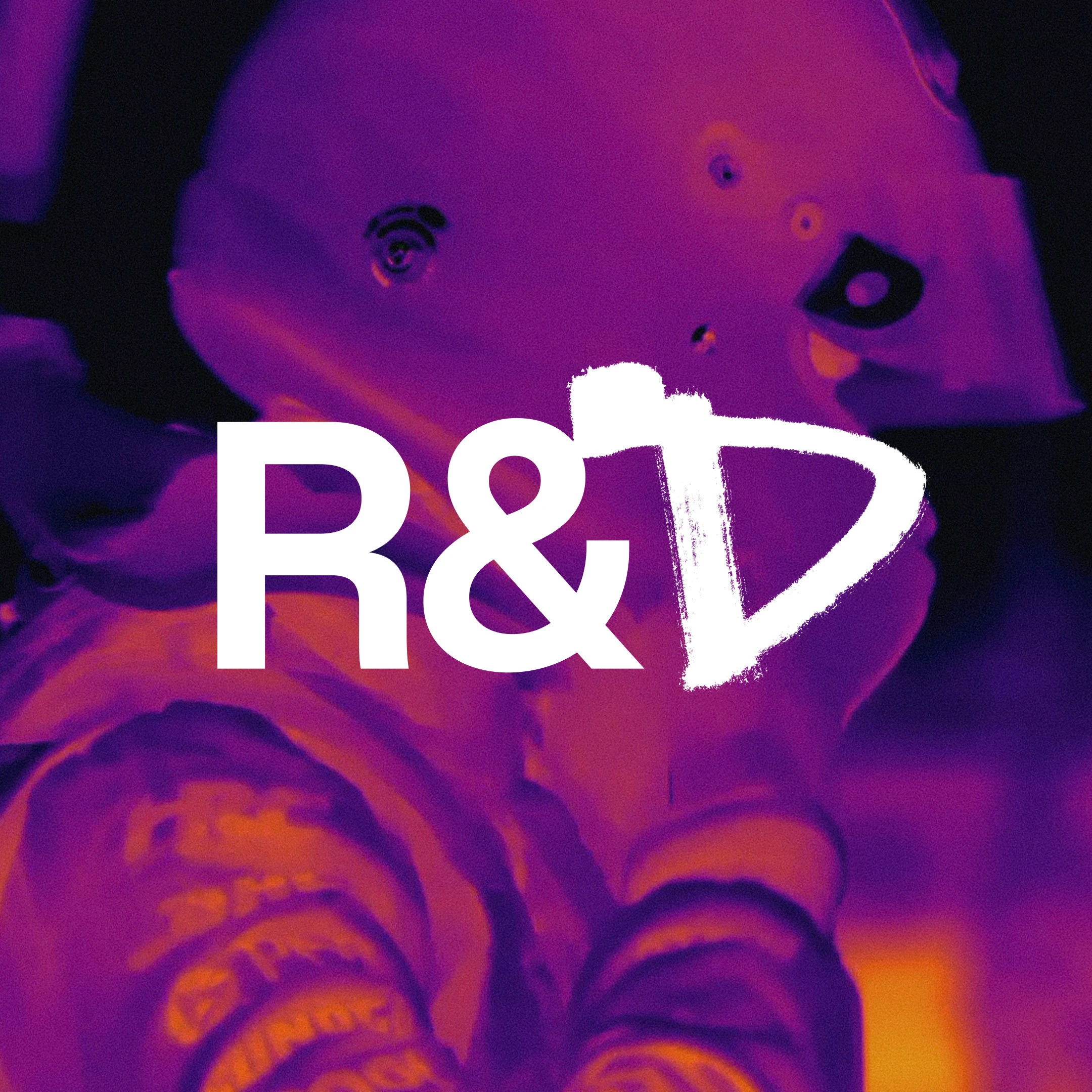 White R&D lettering over a purple and orange thermal image of a racing helmet.
