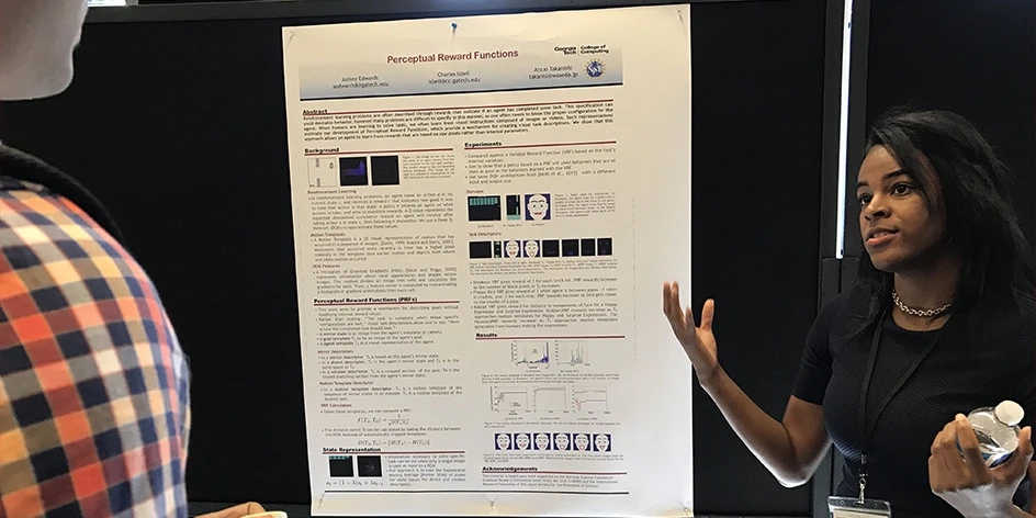 Person presenting their poster at a conference