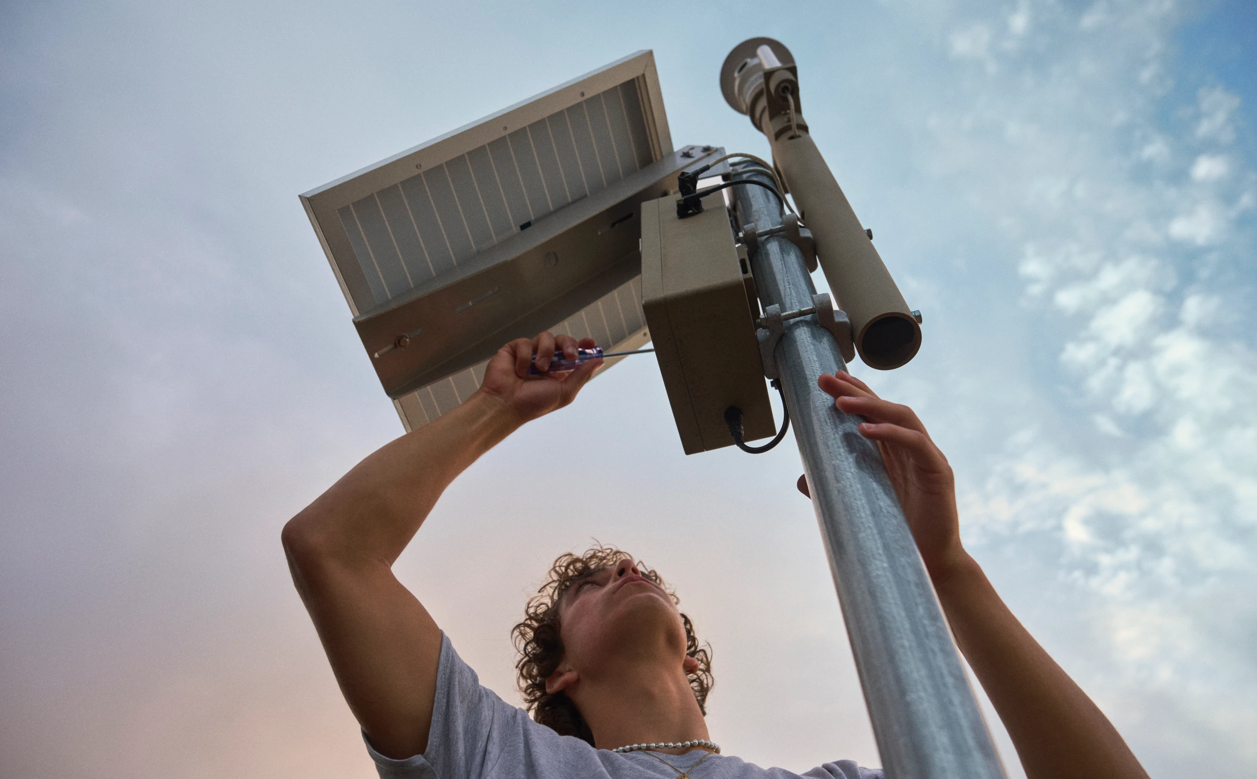 Ryan Honary works with wildfire sensors in a field deployment.