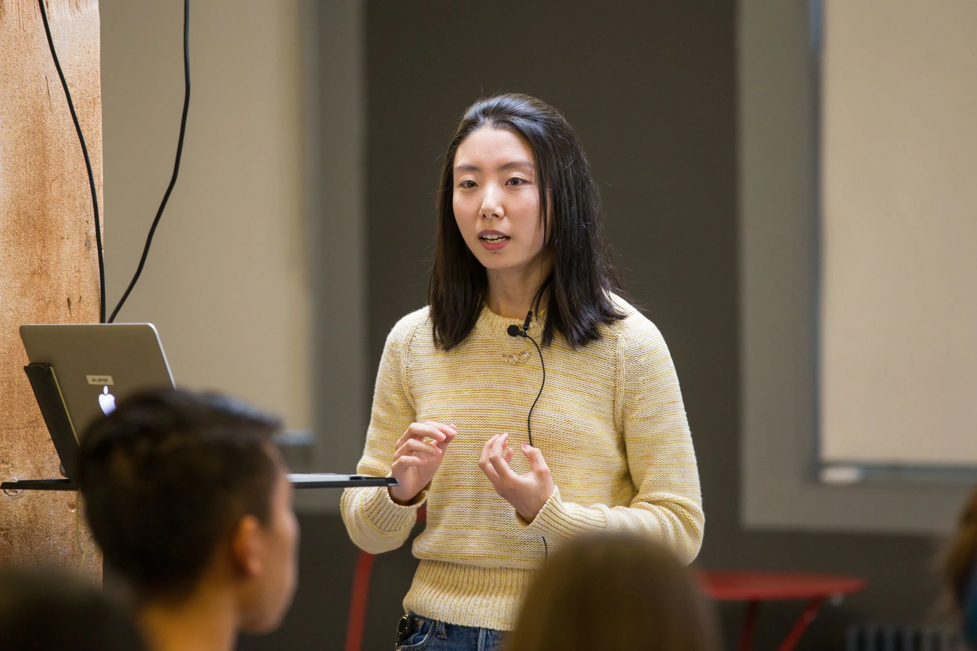 Person giving a talk in front of a live audience