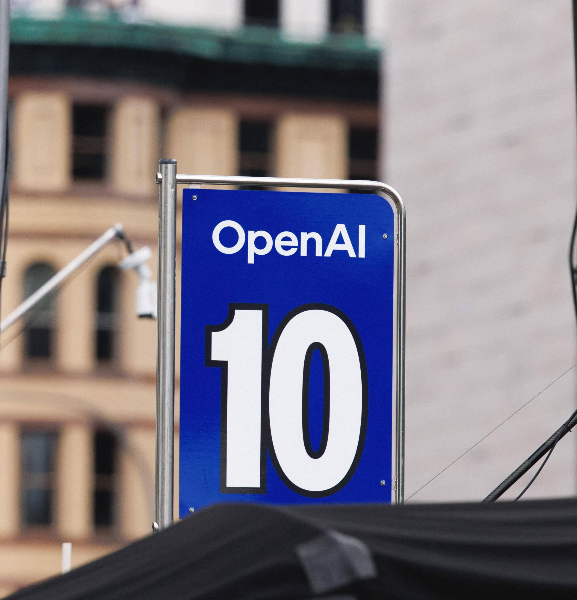 An OpenAI number 10 pit sign beside the racing circuit.