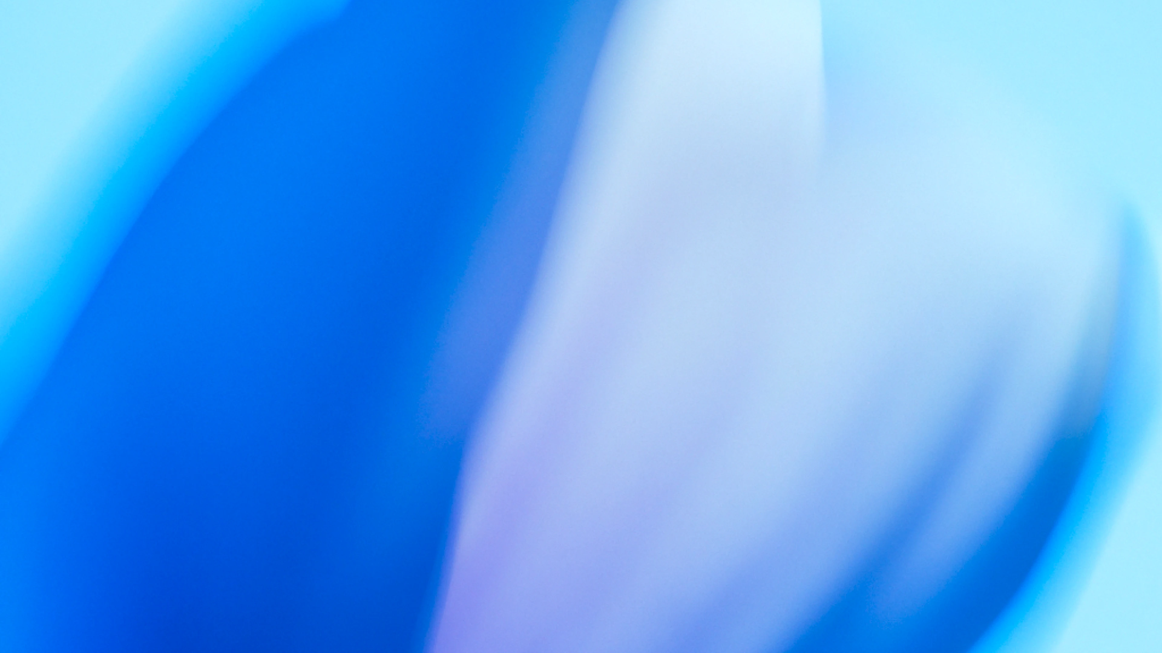 Abstract background with soft blue and purple gradient swirls and blurred shapes.