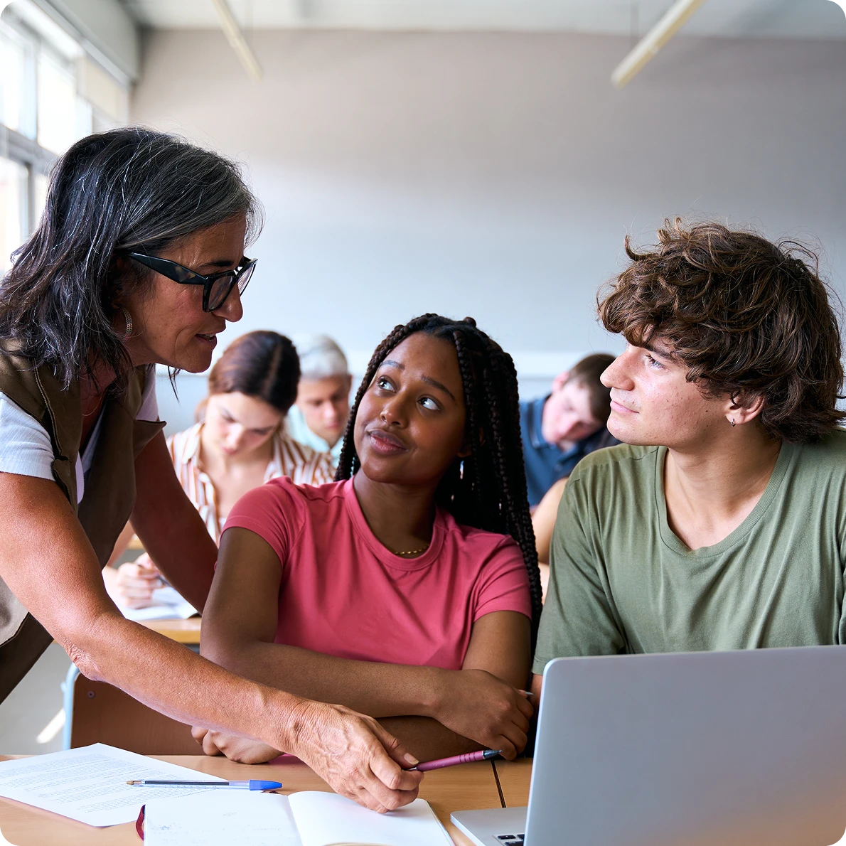 Students learning with an educator in a classroom.