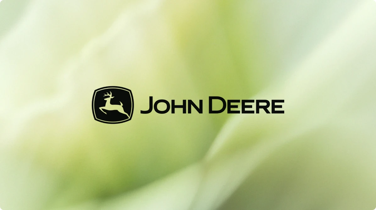 John Deere logo over a green abstract background.