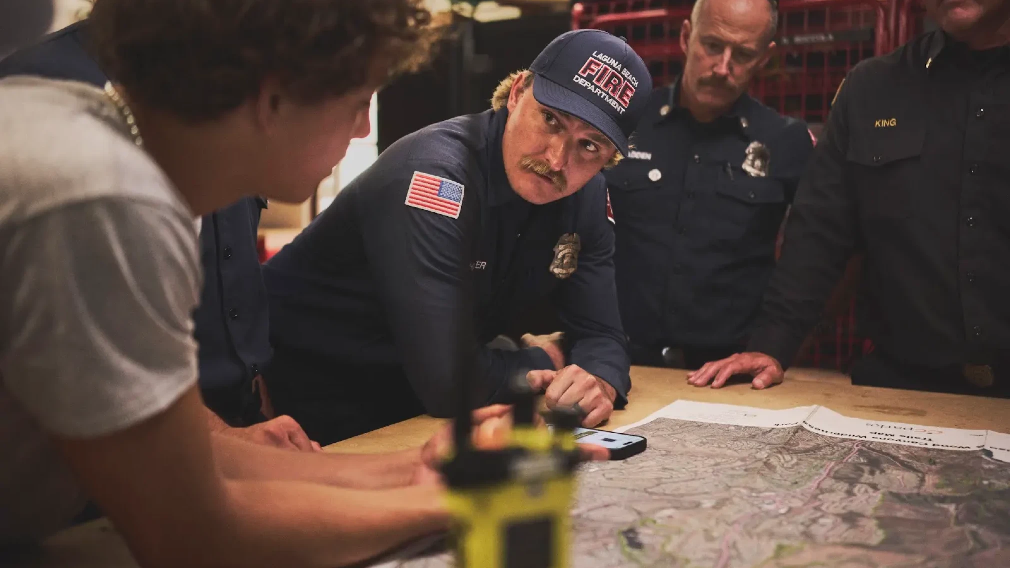 Firefighters review ChatGPT wildfire detection guidance on a screen.