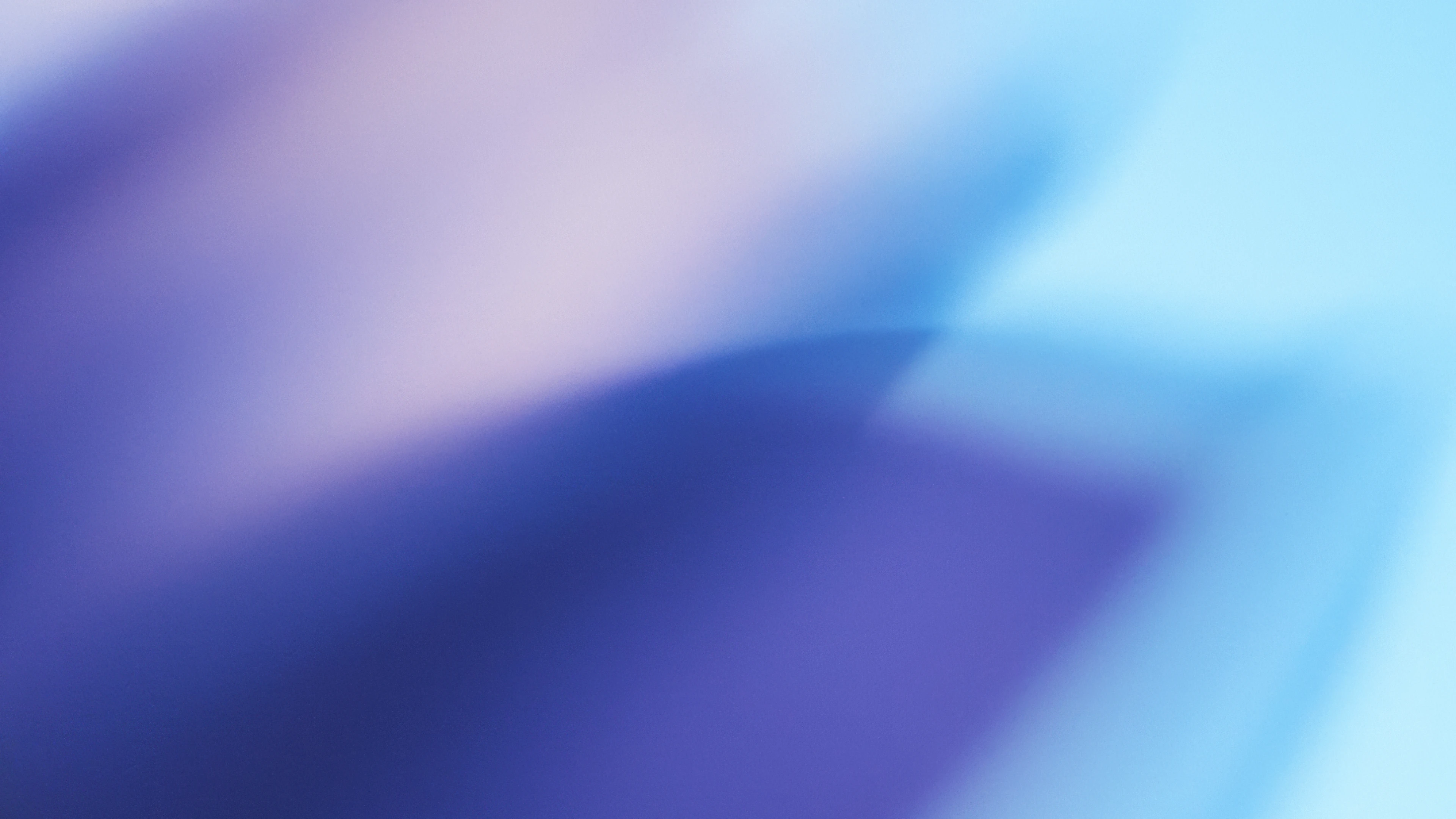 Abstract image featuring blurred gradients of purple and blue with soft light transitions, creating a calm, dreamy atmosphere.