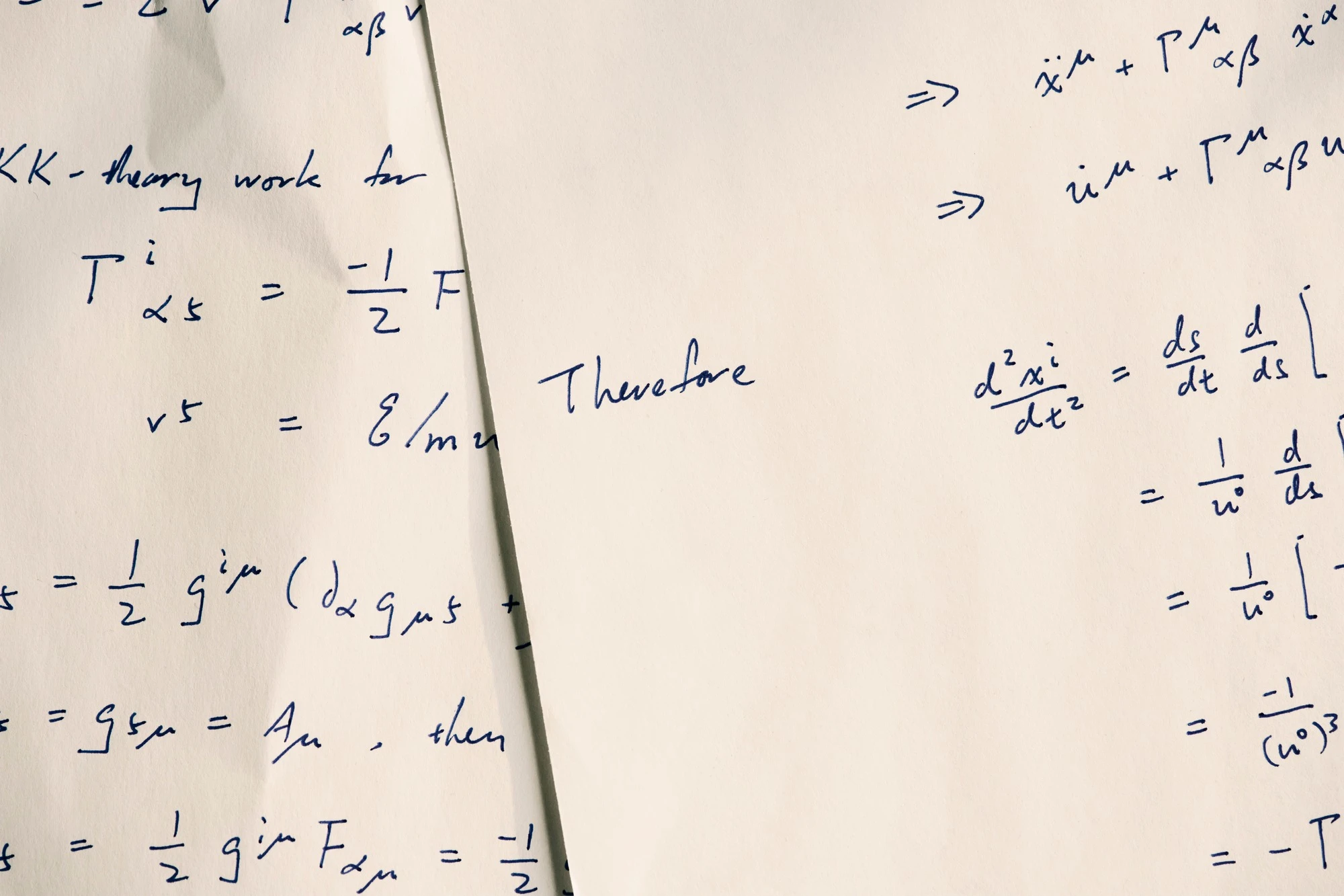 Handwritten equations and notes on paper.