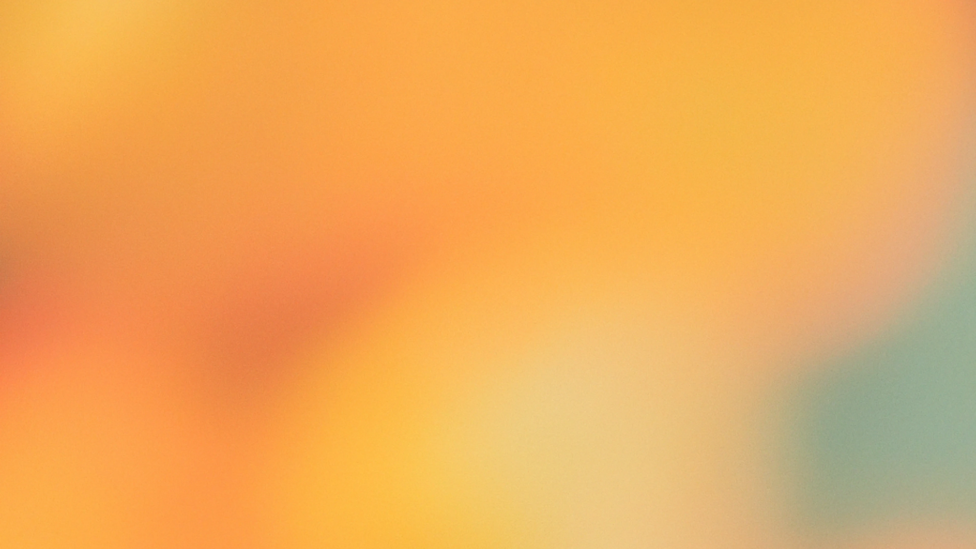 Soft abstract gradient in warm orange and yellow tones with hints of green, creating a blurred, dreamy background.