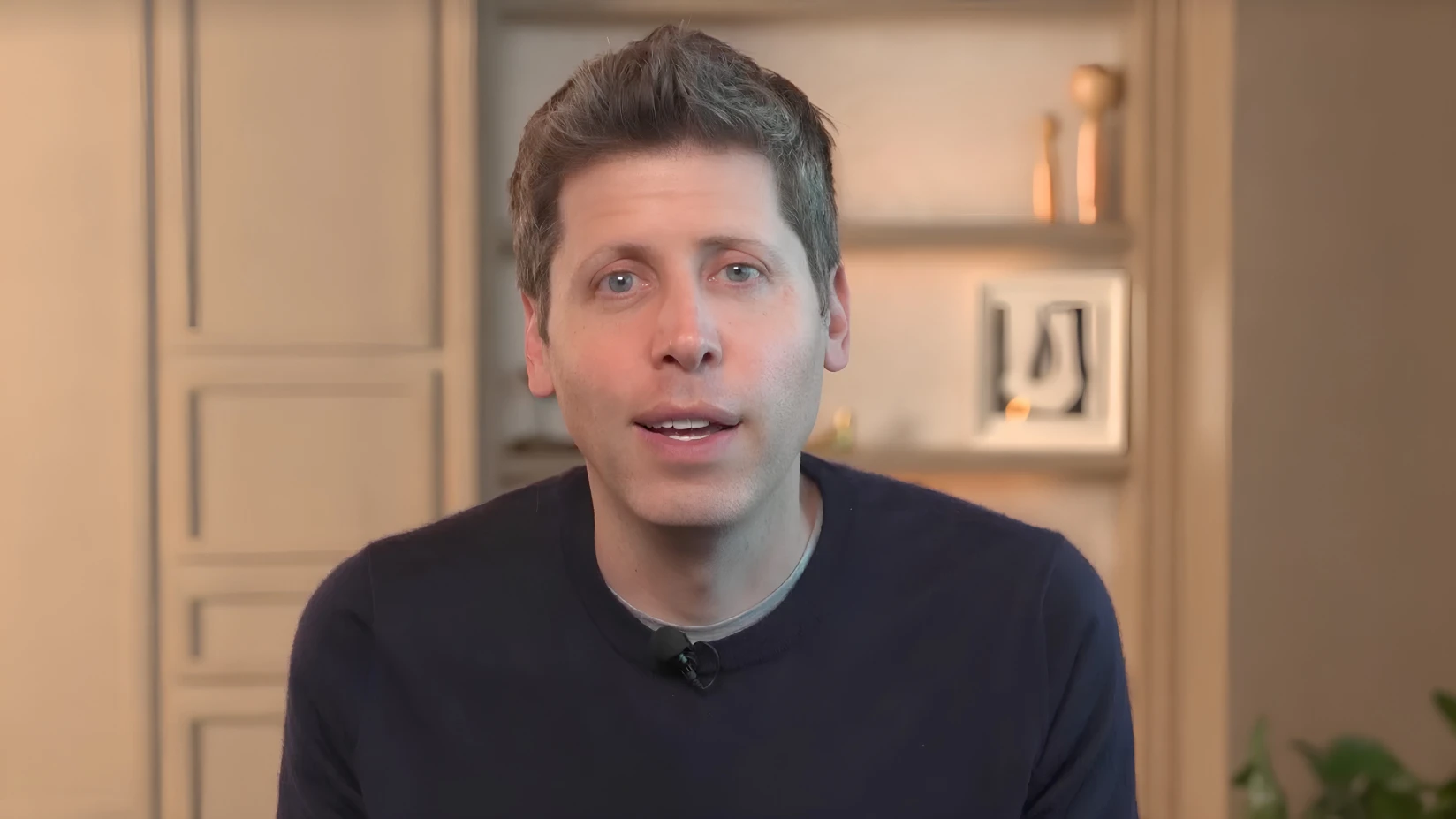 Sam Altman speaks to Brazilian users and developers in a video still.