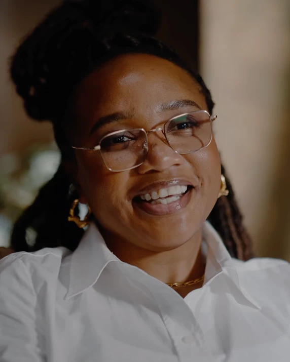 woman wearing glasses smiling