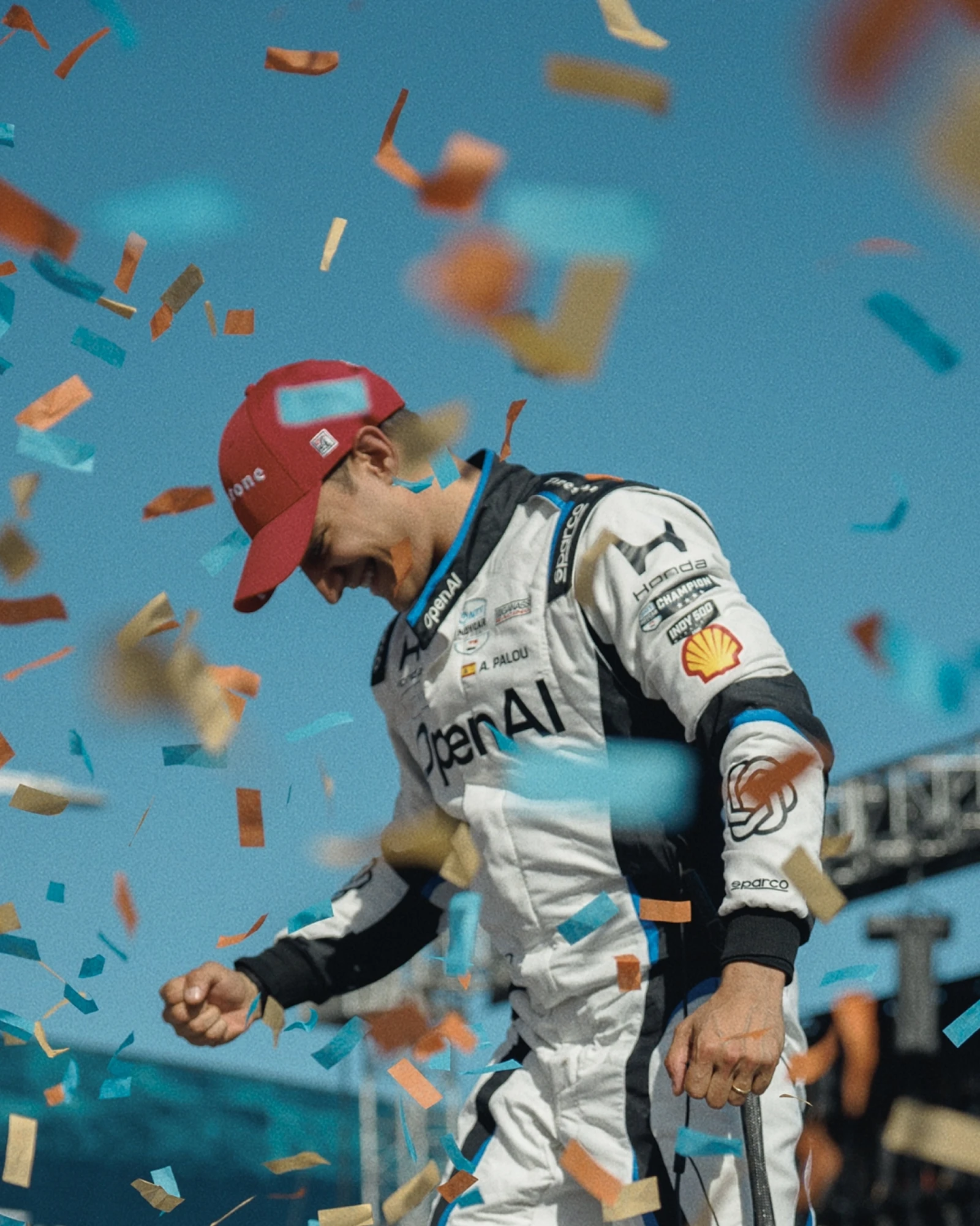 image of a man in a racing uniform surrounded by falling confetti