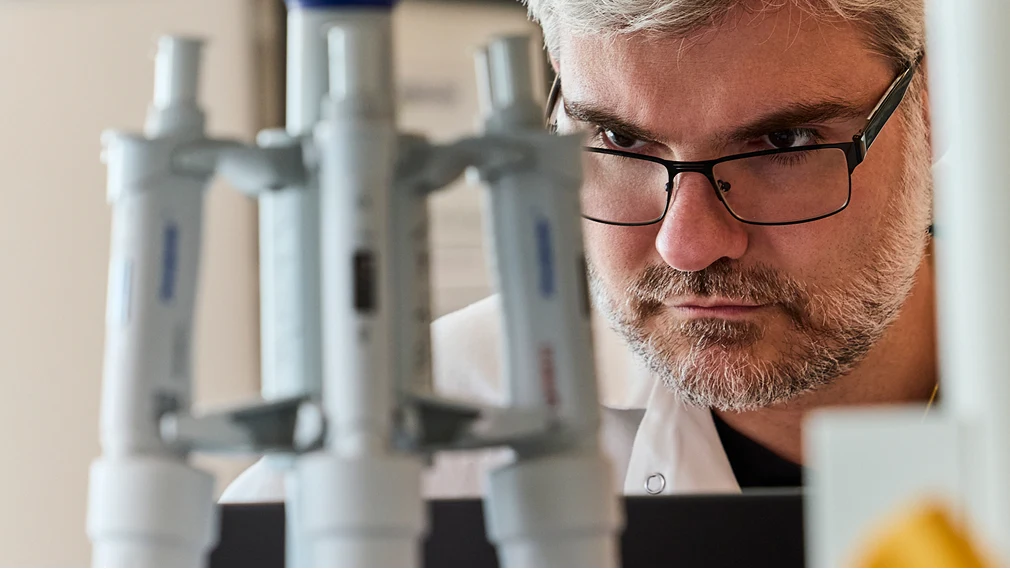 A researcher working at a computer in a lab.