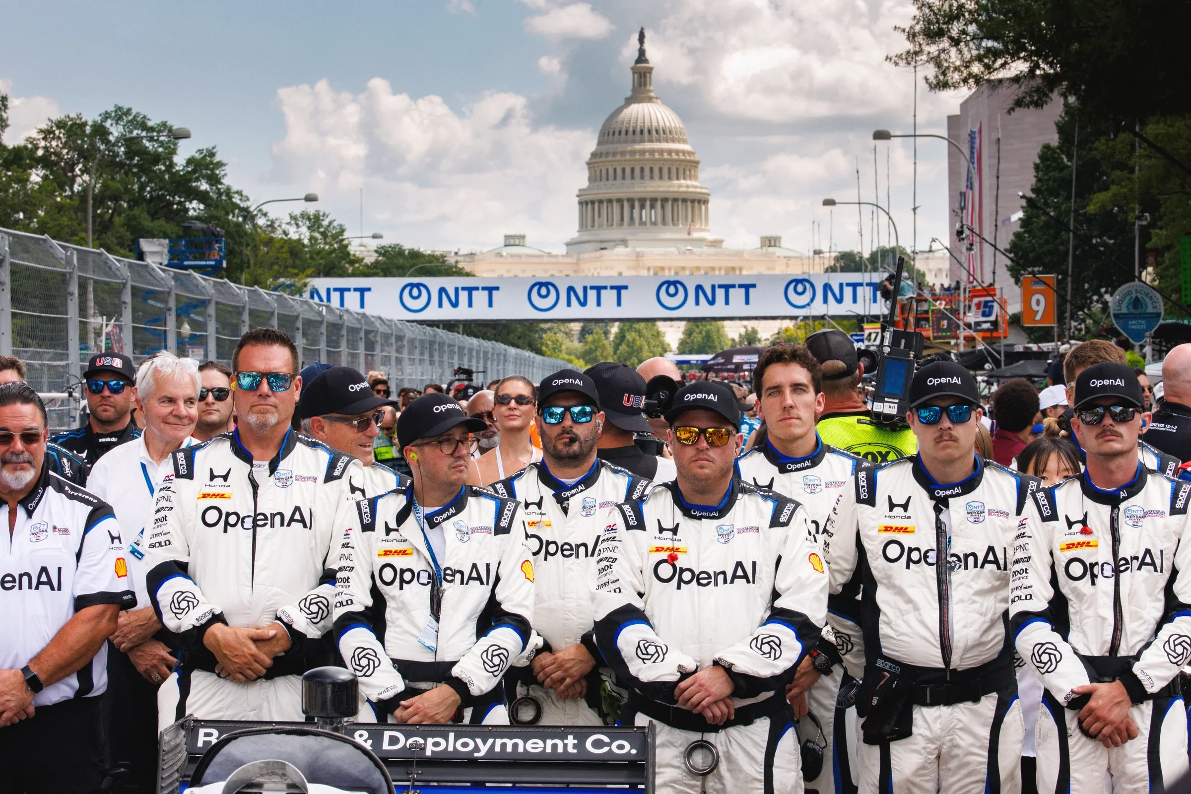 The OpenAI-branded racing team poses together in front of the US Capitol.