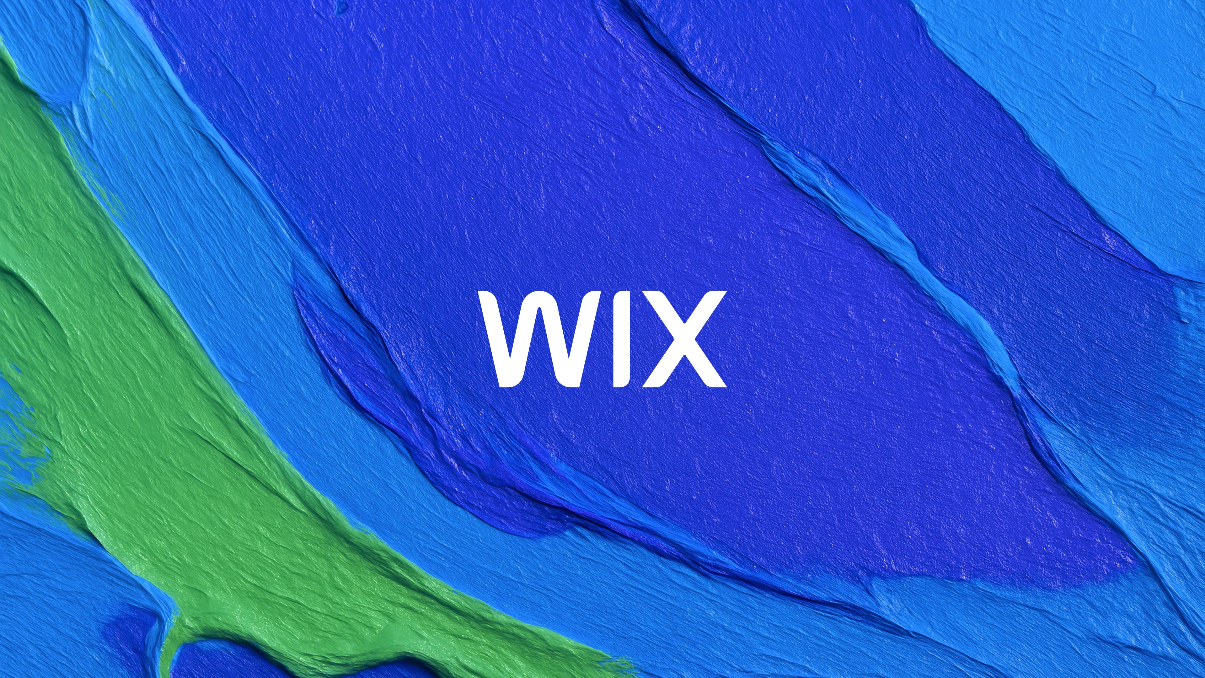 Wix logo in white on a background of blue and green swathes of paint