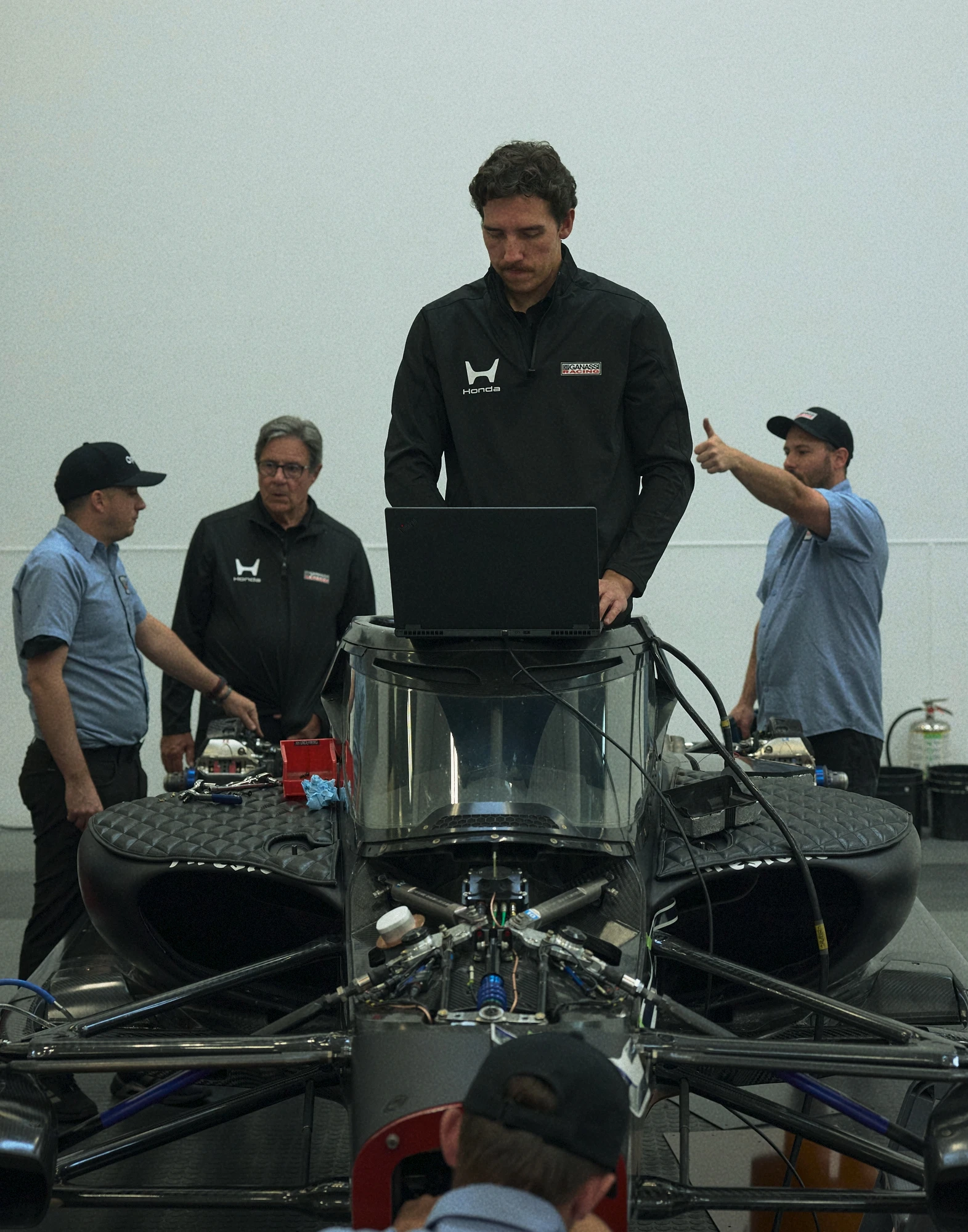 image of indycar engineers working on testing equipment