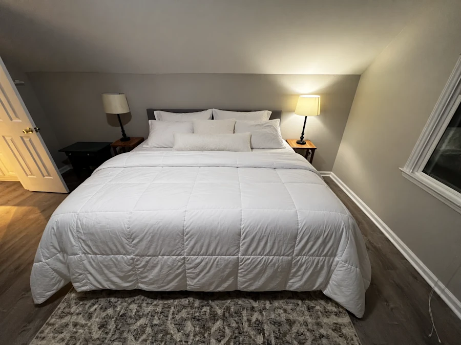 The same bedroom with the bed made, edited by ChatGPT Images 2.5 while the rest of the room is unchanged