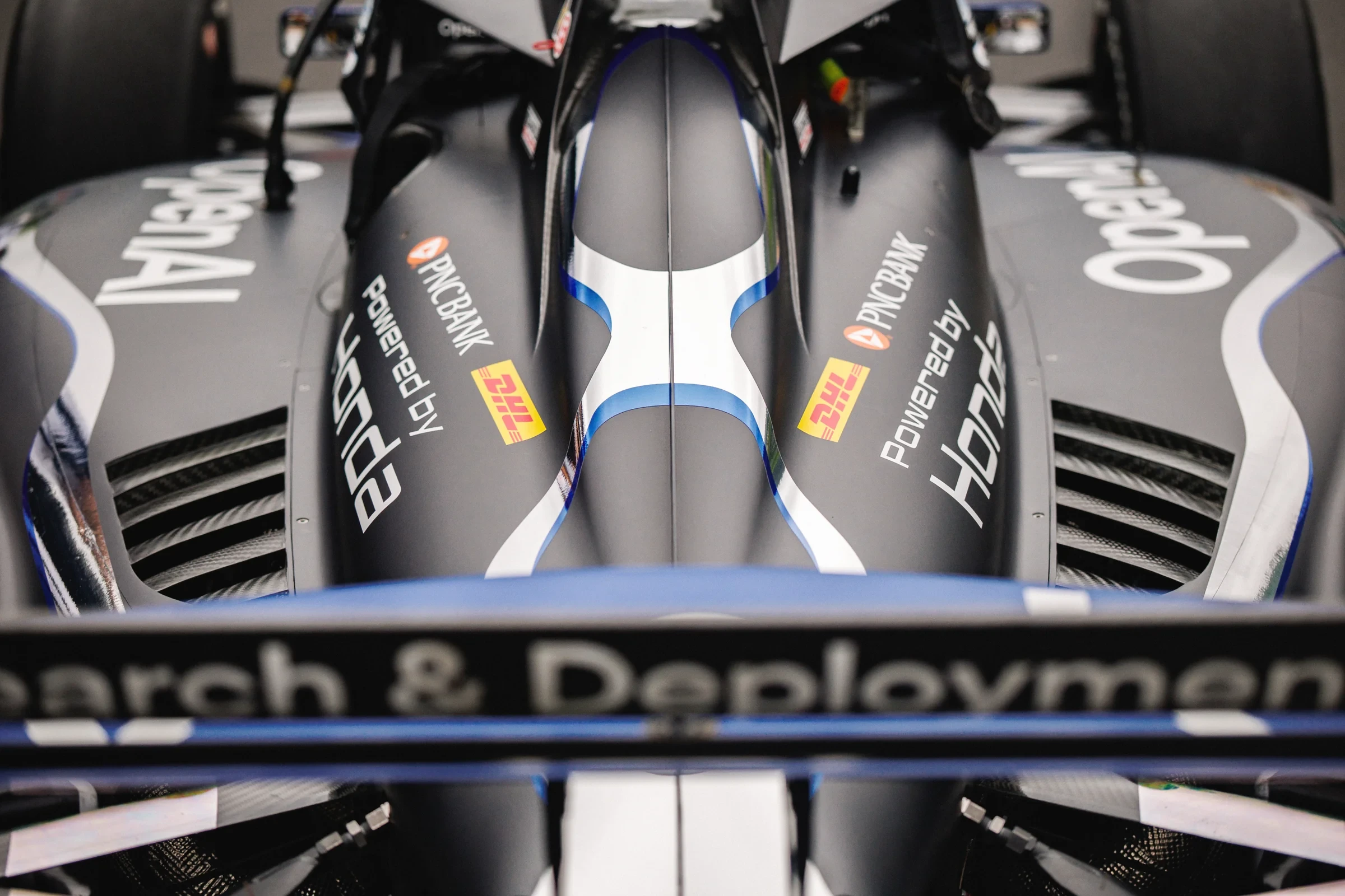 Close-up of the OpenAI-branded IndyCar’s cockpit and bodywork.