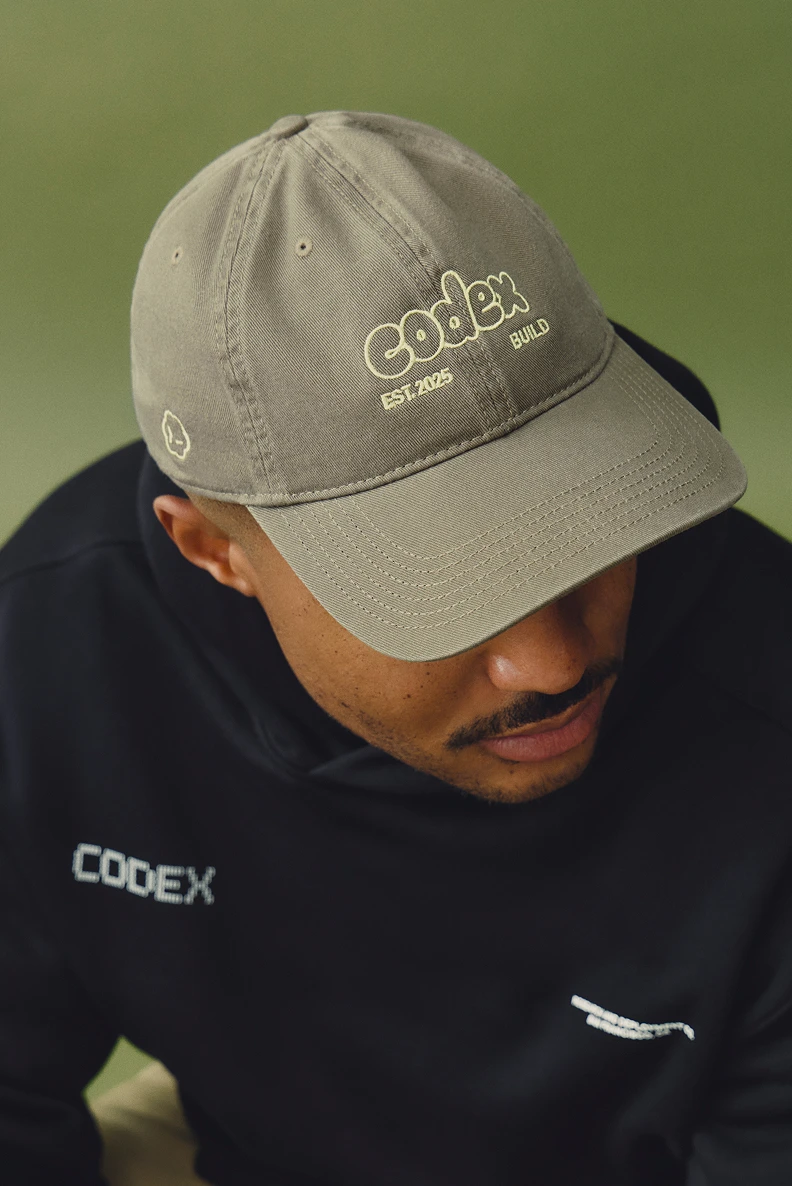 Person wearing a Codex hoodie and embroidered Codex cap