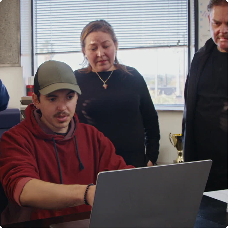 A photograph of a family using ChatGPT to run their tamale shop