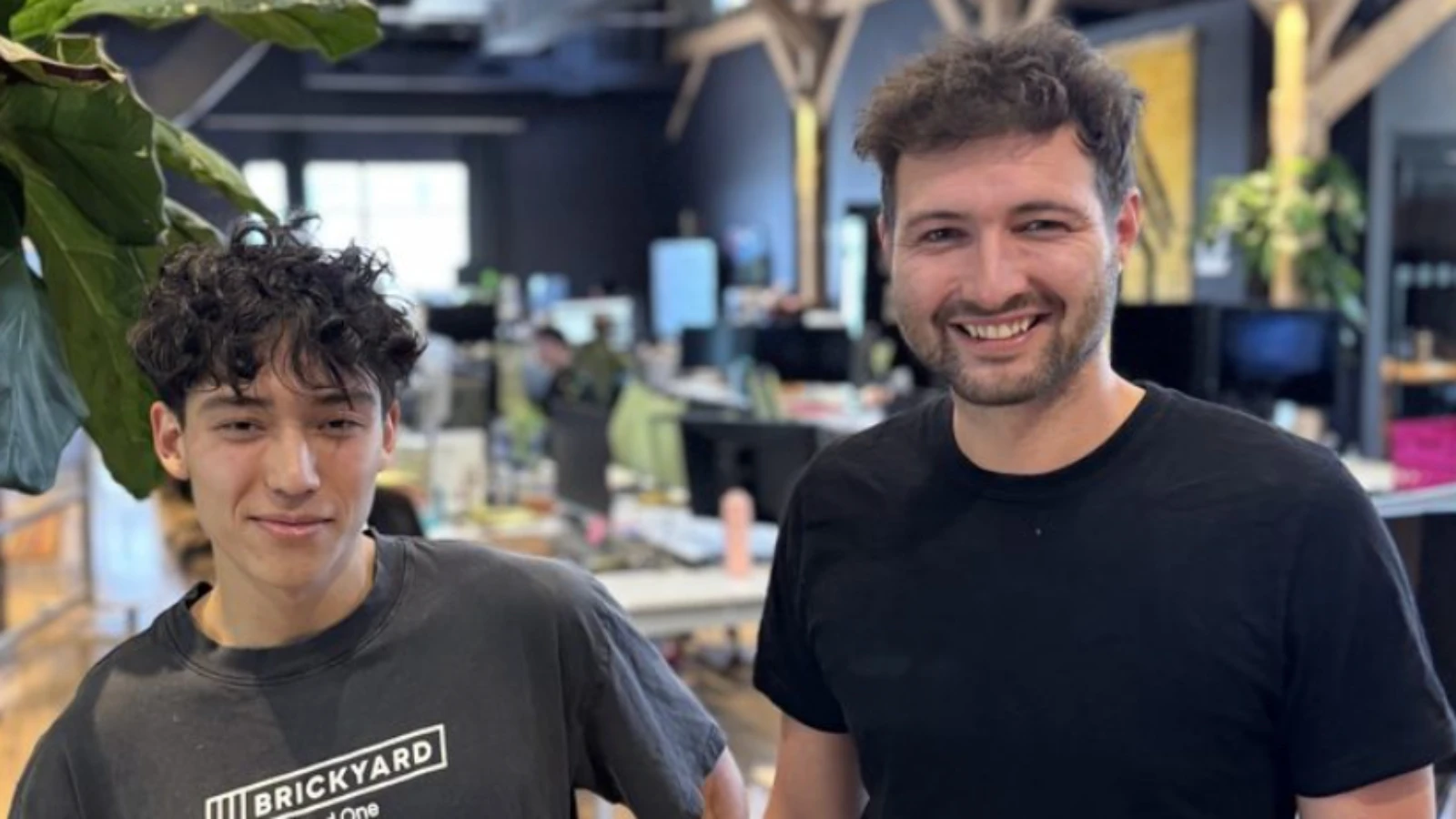 Two people pictured in Goliath Data’s Academy story, standing in an office.