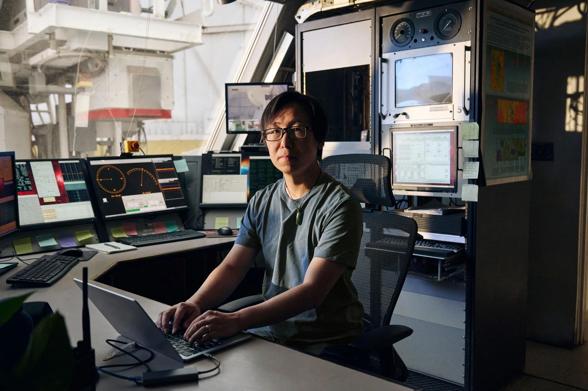 CK Chan seated among research monitors and scientific workstations.
