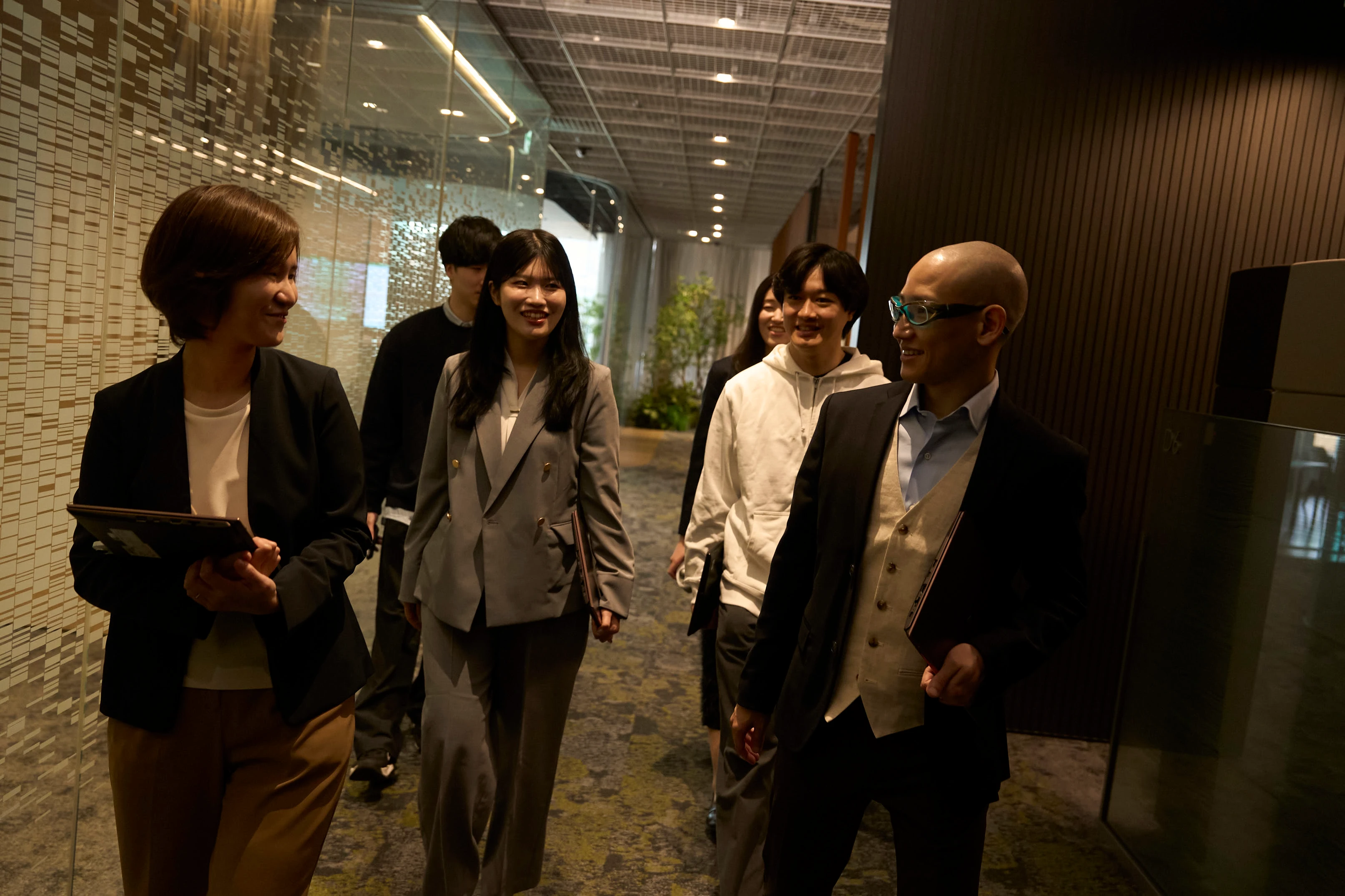 MUFG team members walking together in an office corridor.