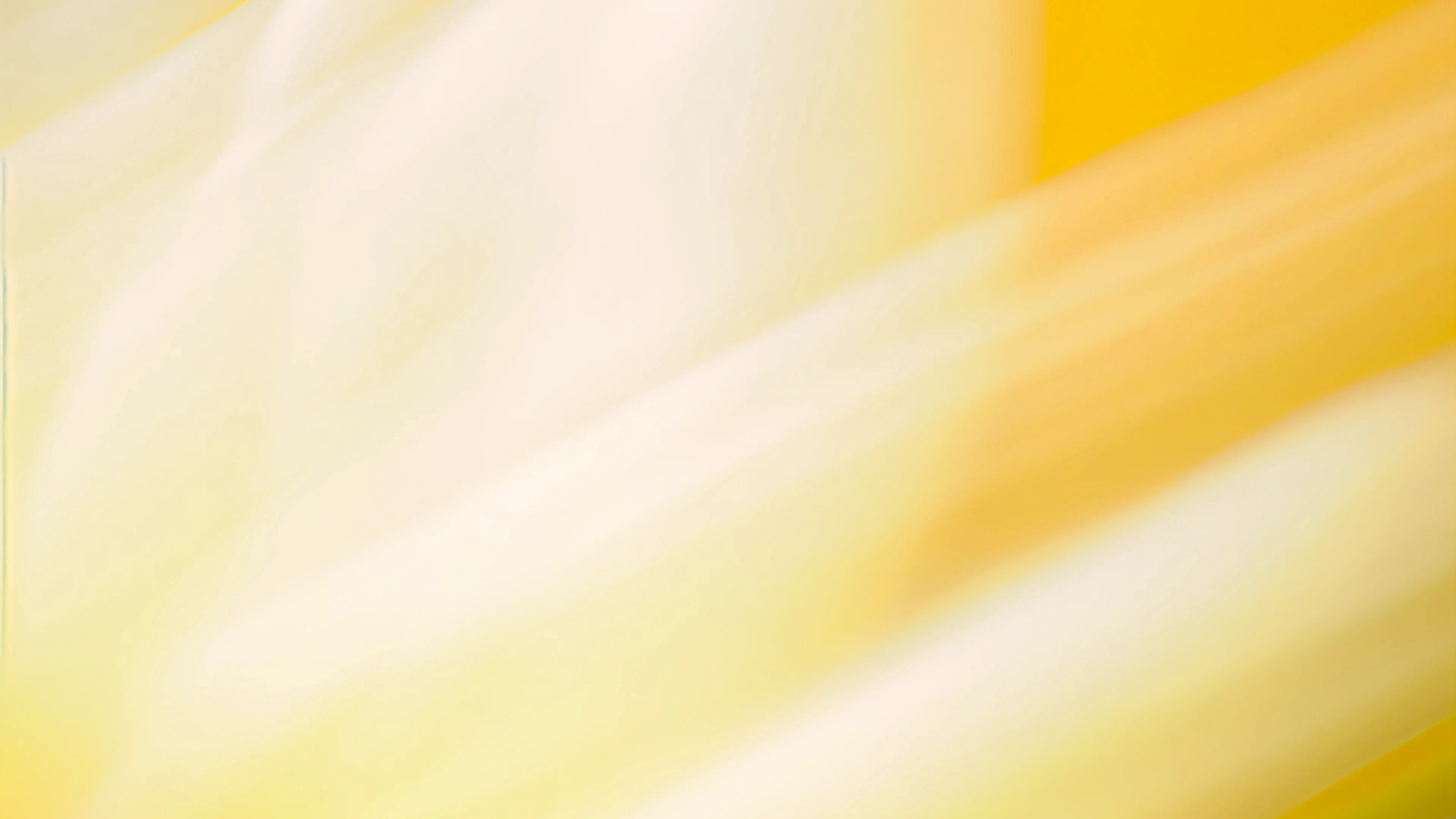 Abstract background with soft yellow and white gradient swirls and blurred light streaks.