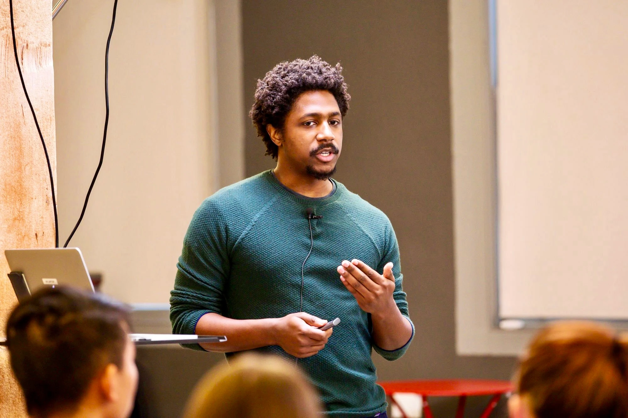 OpenAI Scholar presenting their 2019 Final Project while a live audience looks on