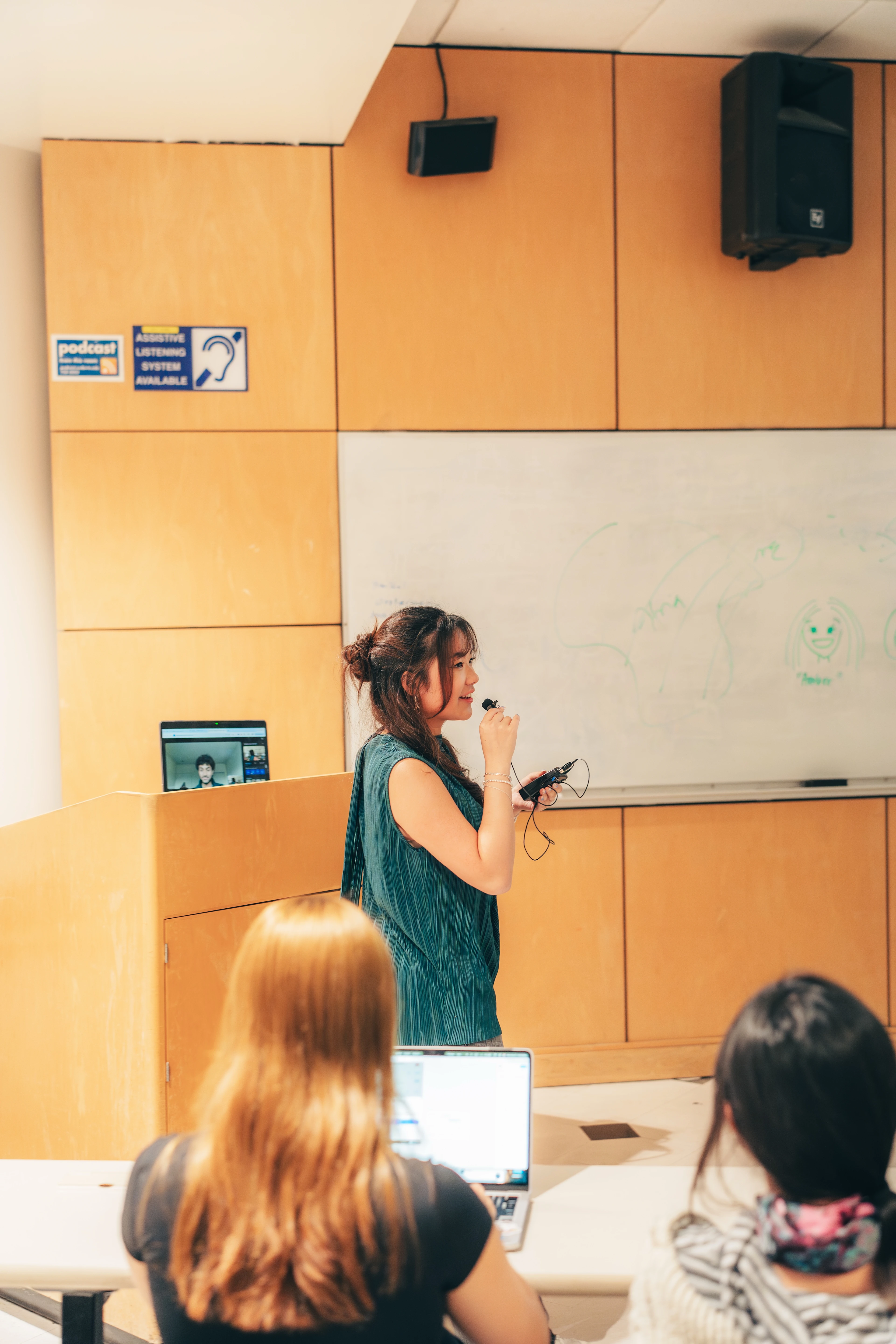 Arlina Yang speaking to students in a university classroom.