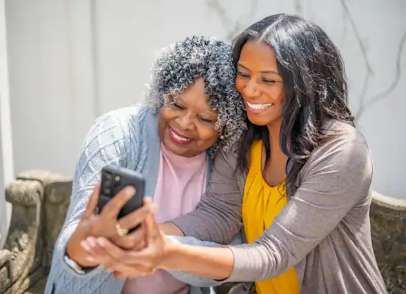 Caregiver and loved one with a phone