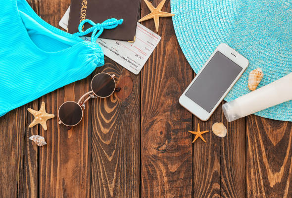 Composition with passport, ticket and beach items on wooden background