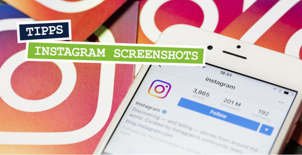 Smartphone mit geöffneter Instagram-App auf Instagram-Symbolen liegend.