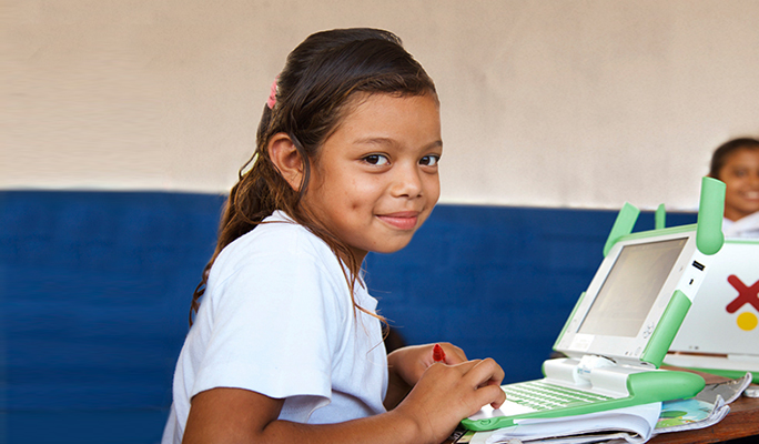 A school child at her desk in a classroom