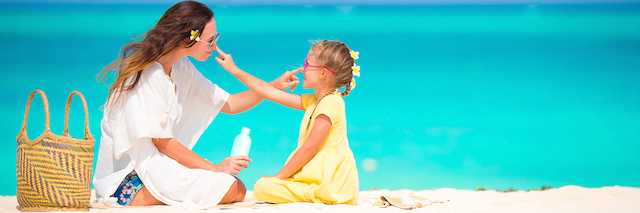 Woman playing with child on beach